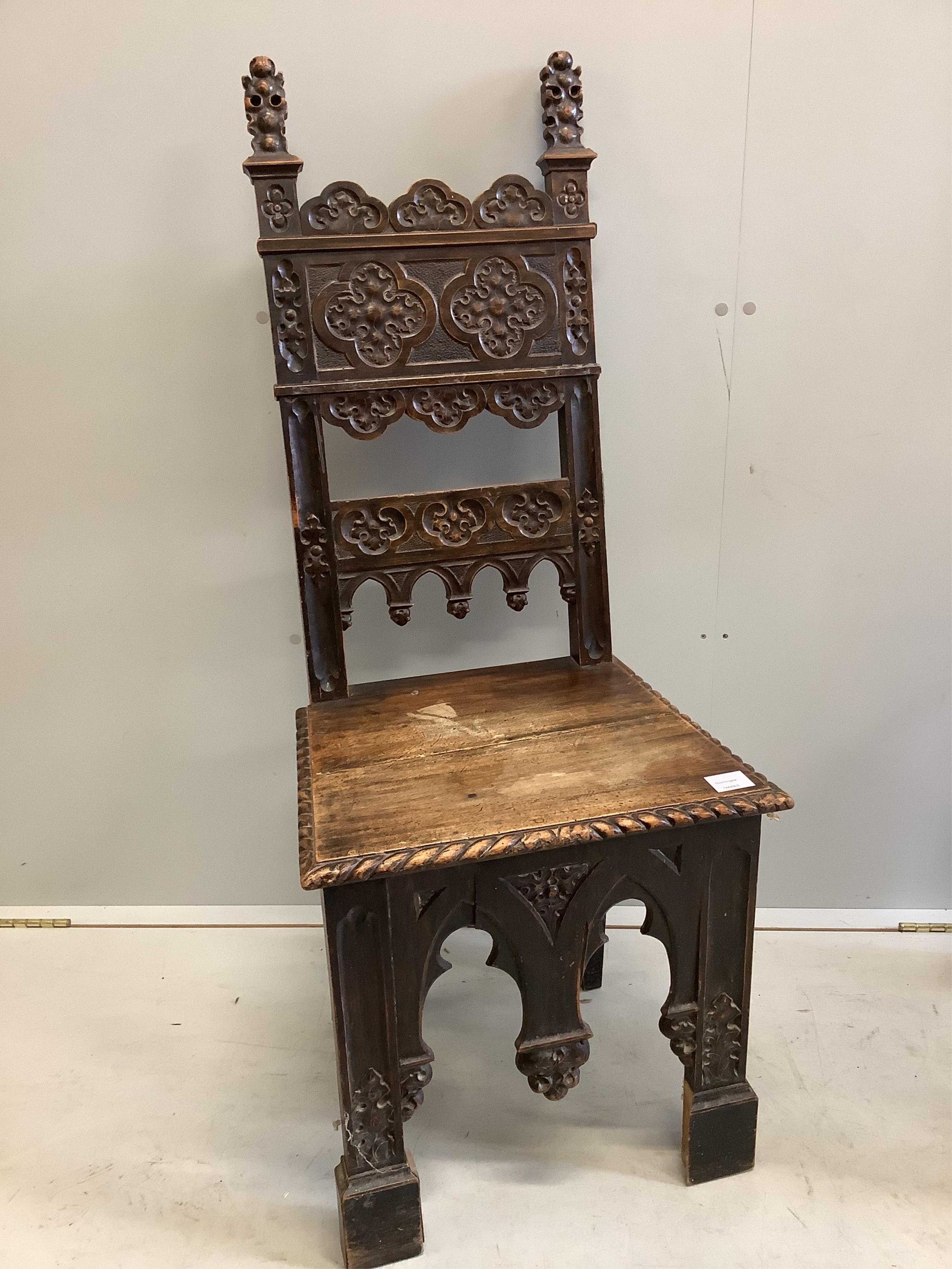 A pair of 19th century Italian walnut hall chairs, width 48cm, depth 39cm, height 118cm. Condition - fair